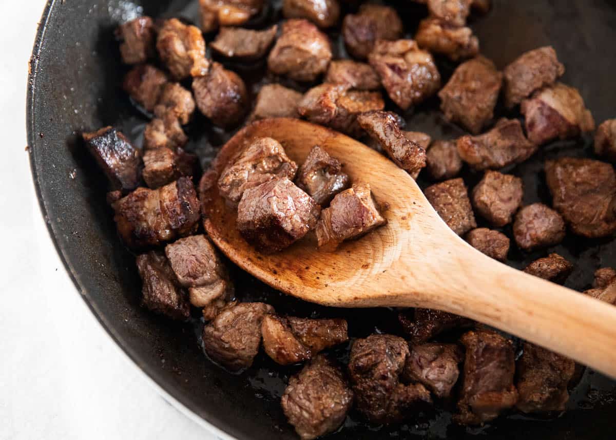 Steak bites in pan.
