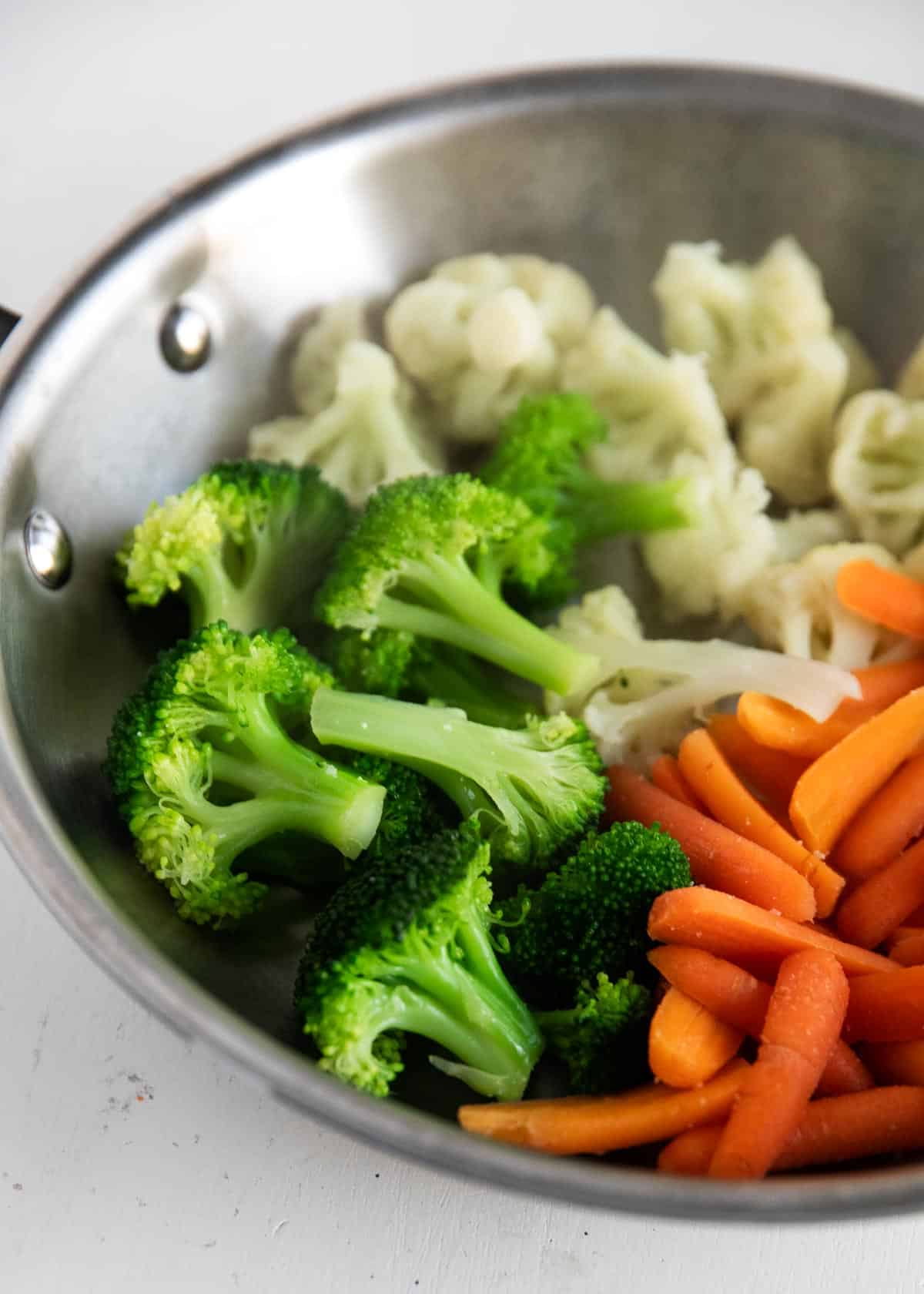 Steamed vegetables cooked in pan.