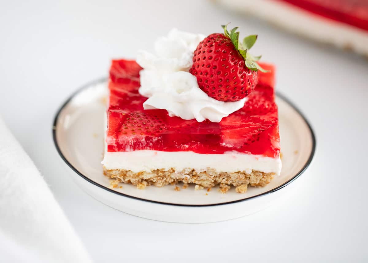 Strawberry pretzel salad on white plate.