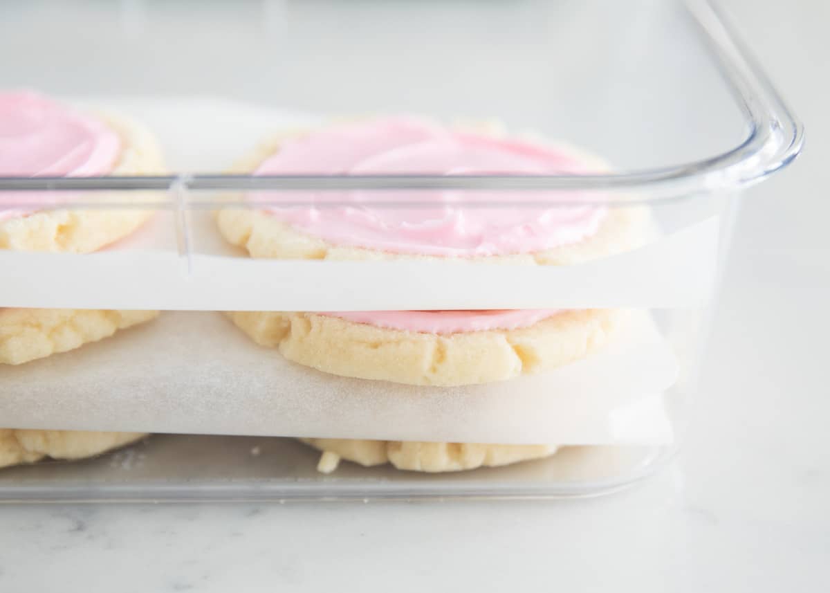 Swig cookies with frosting in pan.