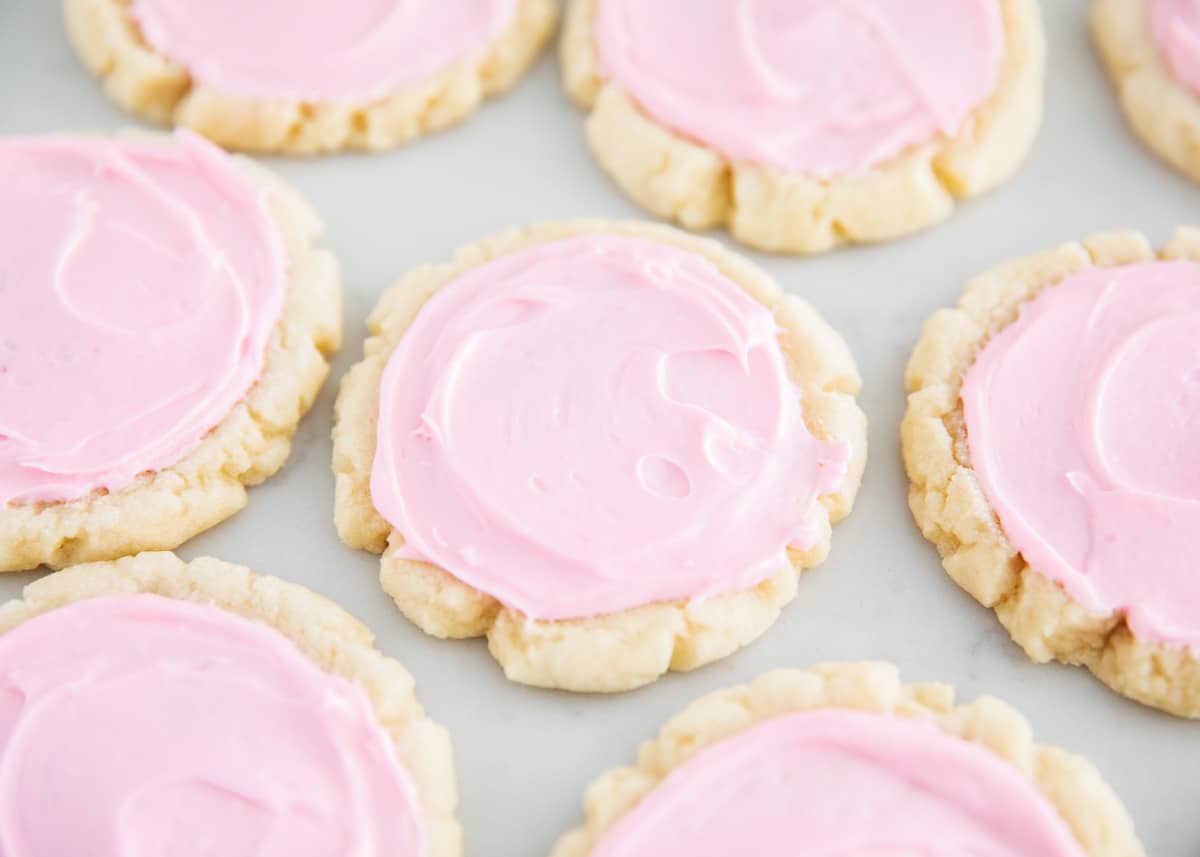 Swig cookies with frosting on table.