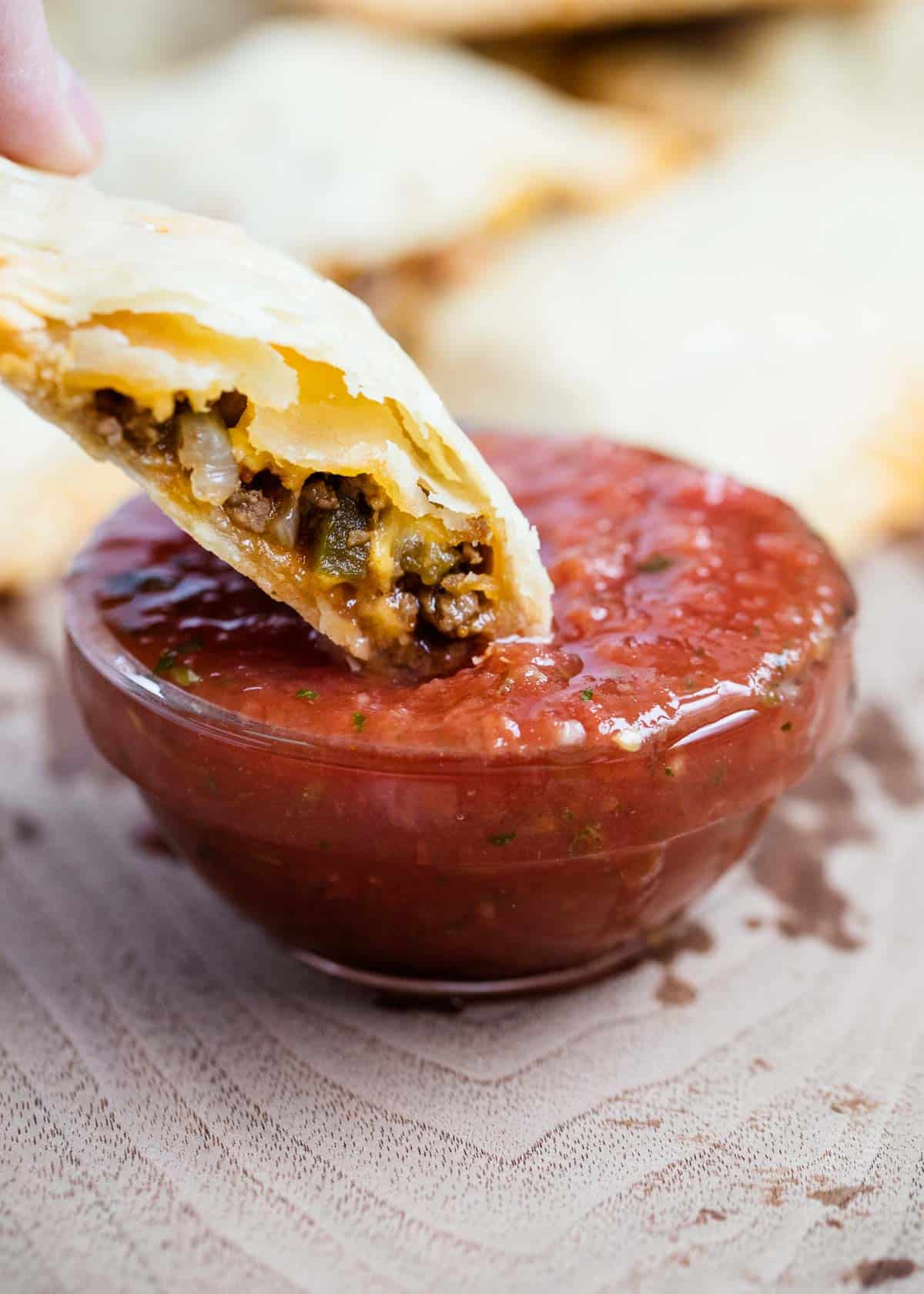 Dipping taco pocket in salsa.