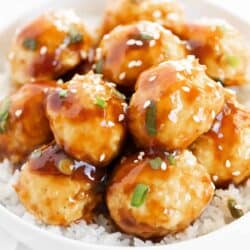 Teriyaki meatballs in a bowl with white rice.