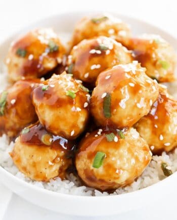 Teriyaki meatballs in a bowl with white rice.