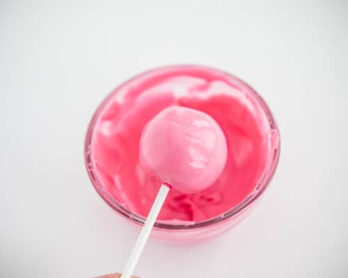 dipping cake pop in pink chocolate
