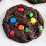 Chocolate m&m cookie on a baking sheet.