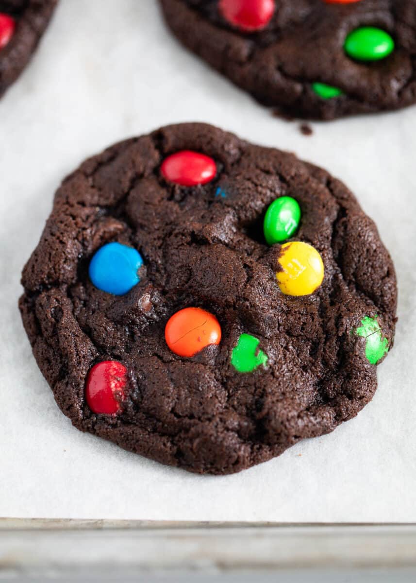 Chocolate m&m cookie on a baking sheet. 