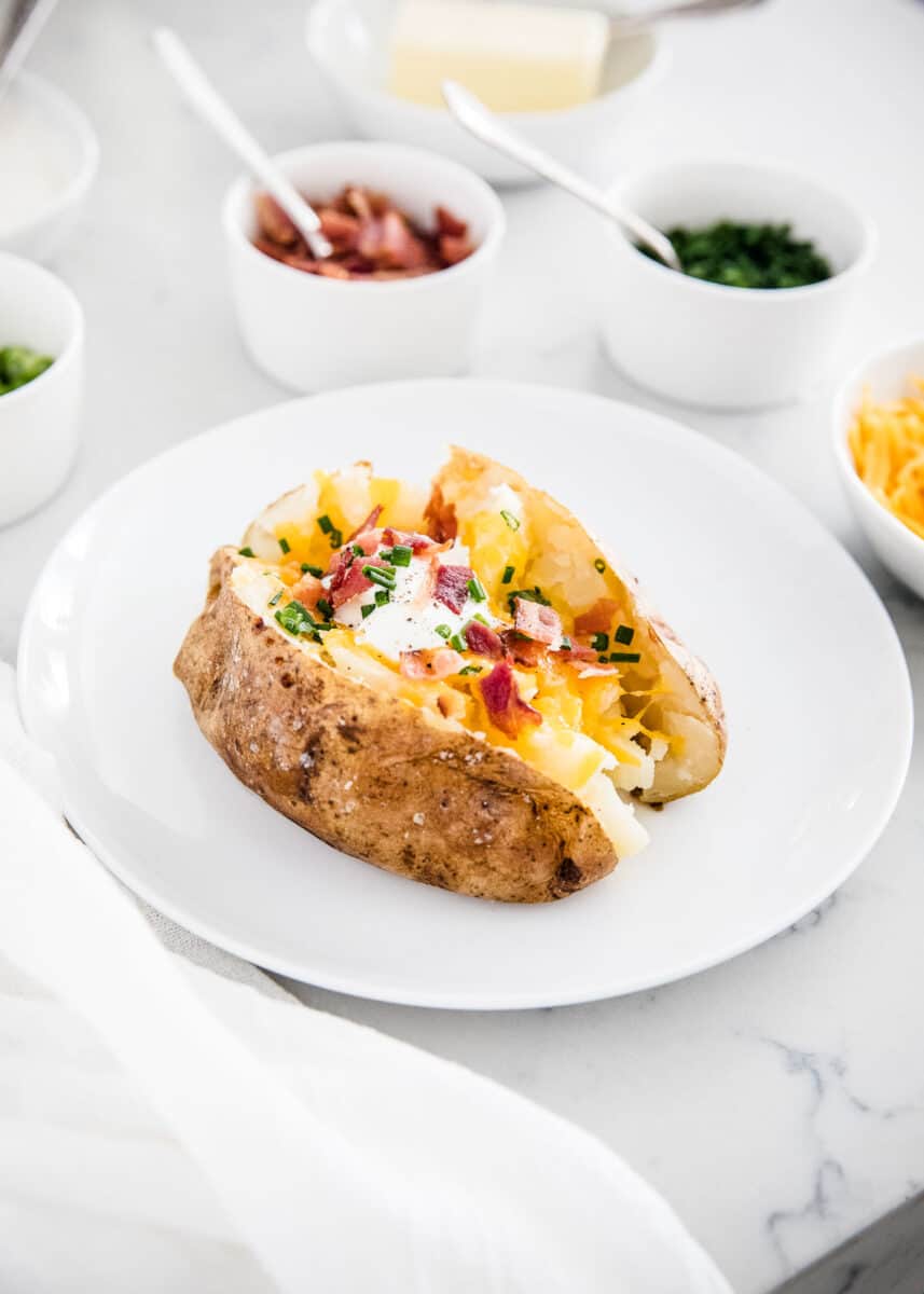 loaded baked potato on white plate