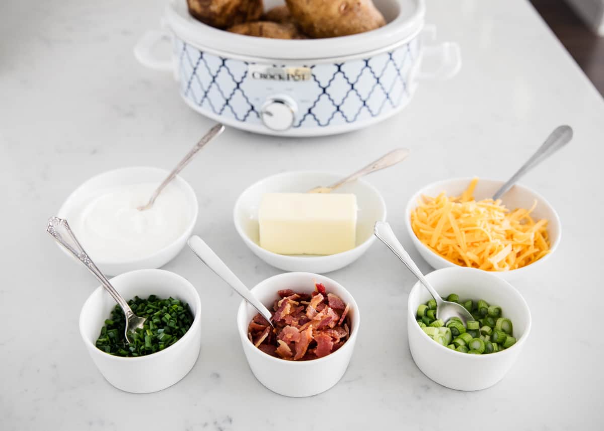 Baked potato bar toppings in bowls
