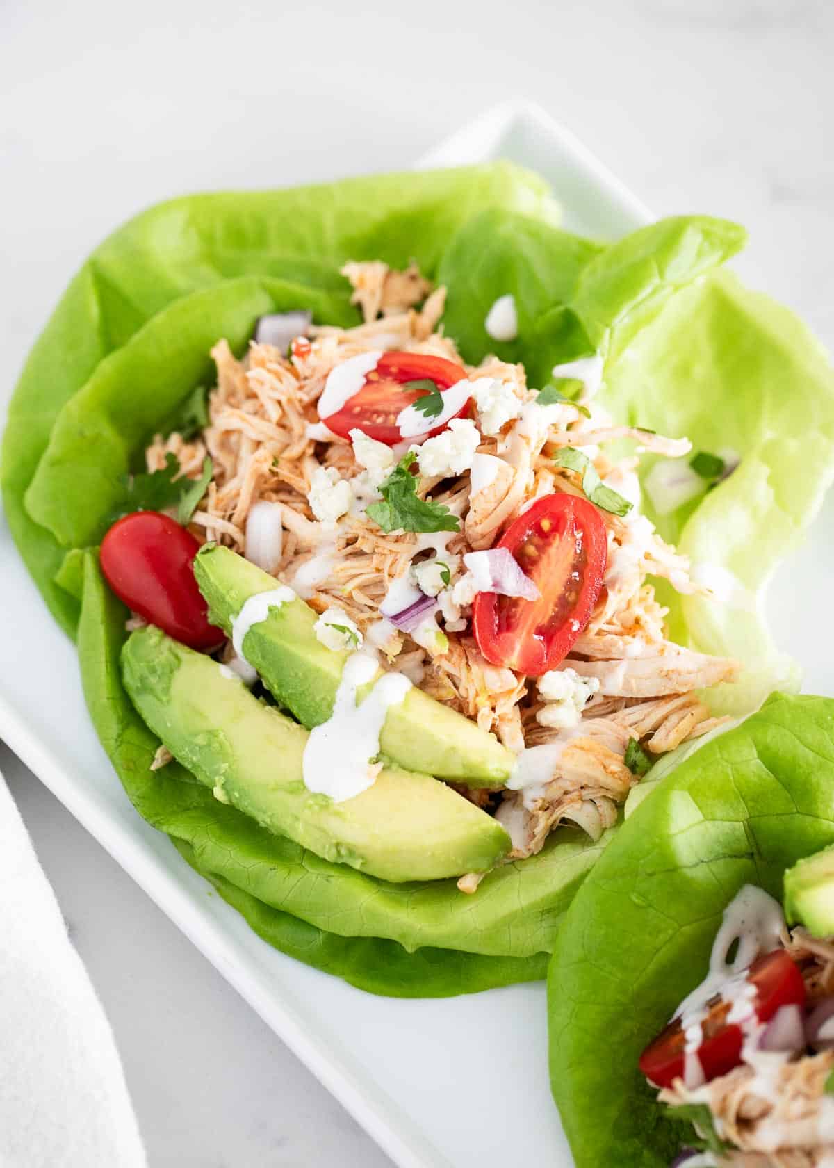 Buffalo chicken lettuce wraps on plate.