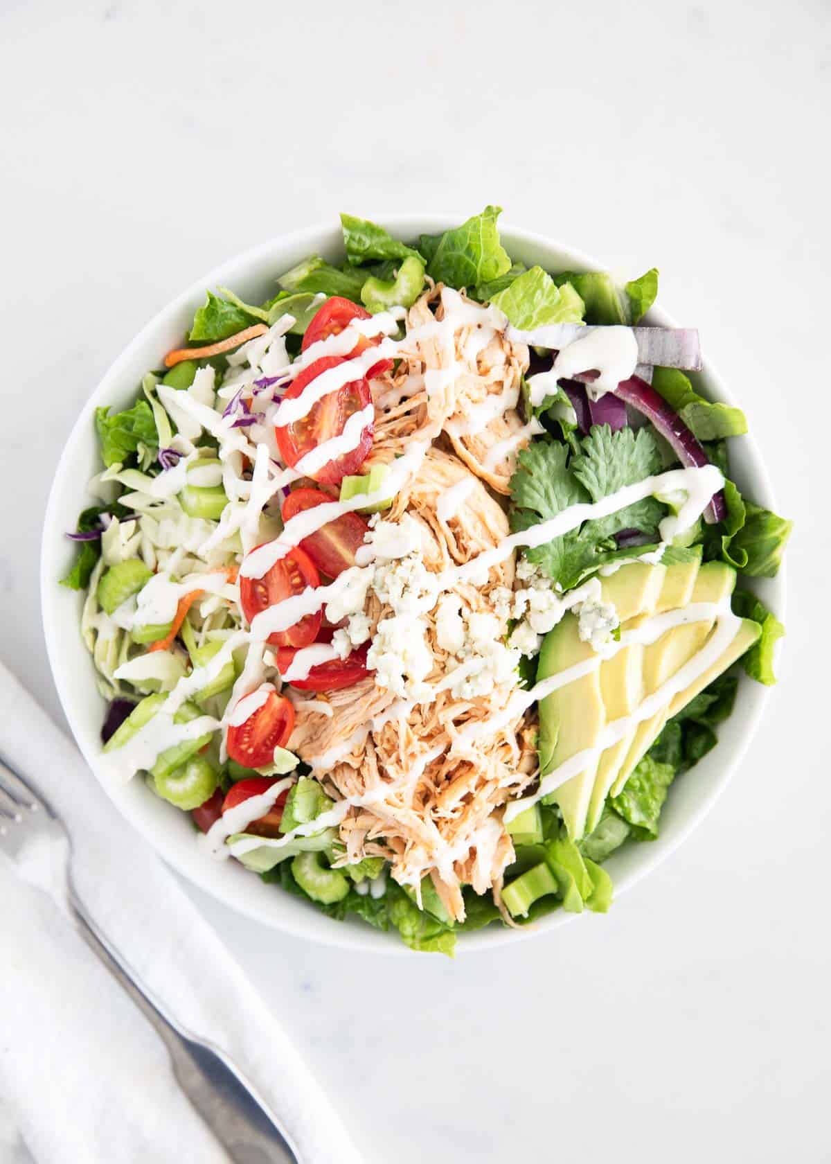 Buffalo chicken salad in white bowl.