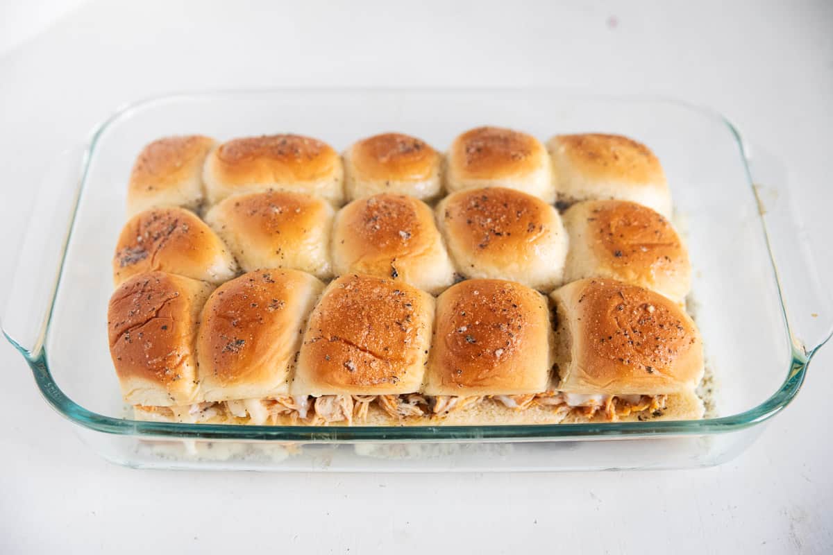 Buffalo chicken sliders in pan.