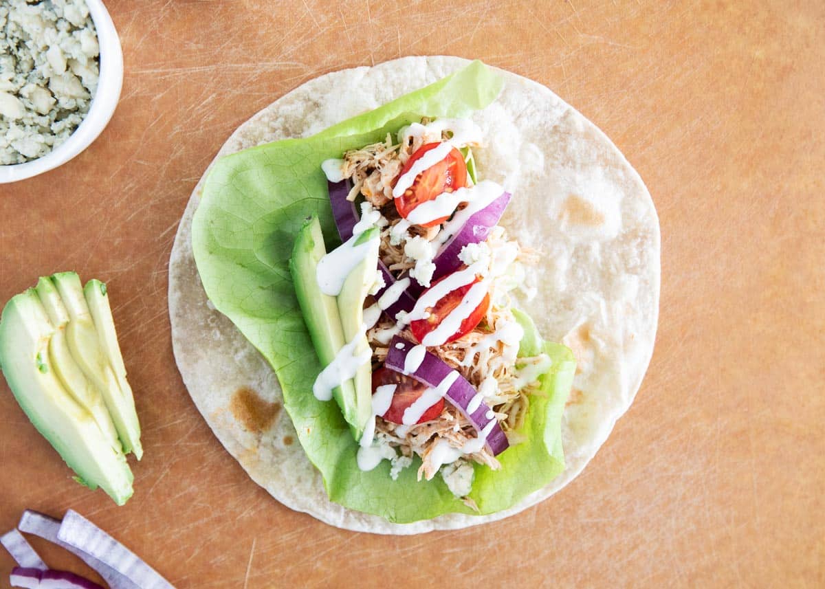 Buffalo chicken wrap on cutting board.