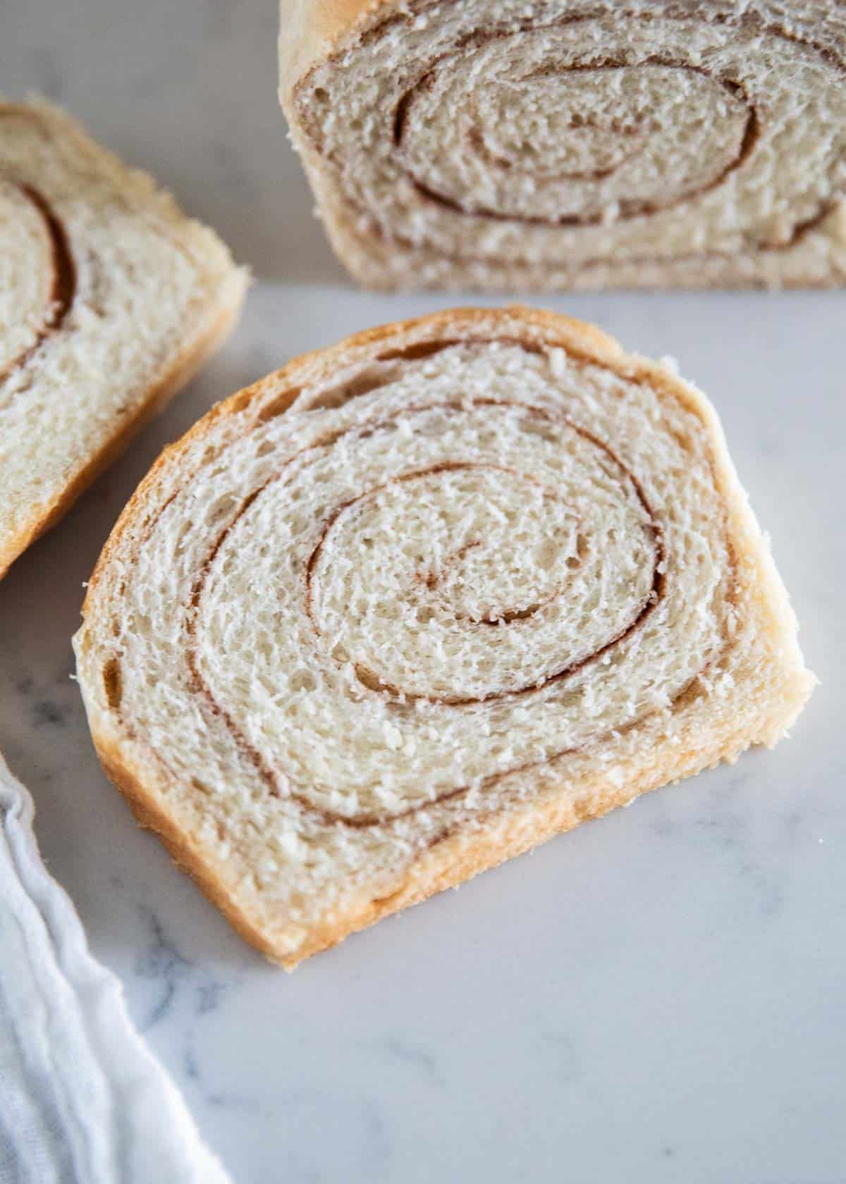 Cinnamon swirl bread slice on table.