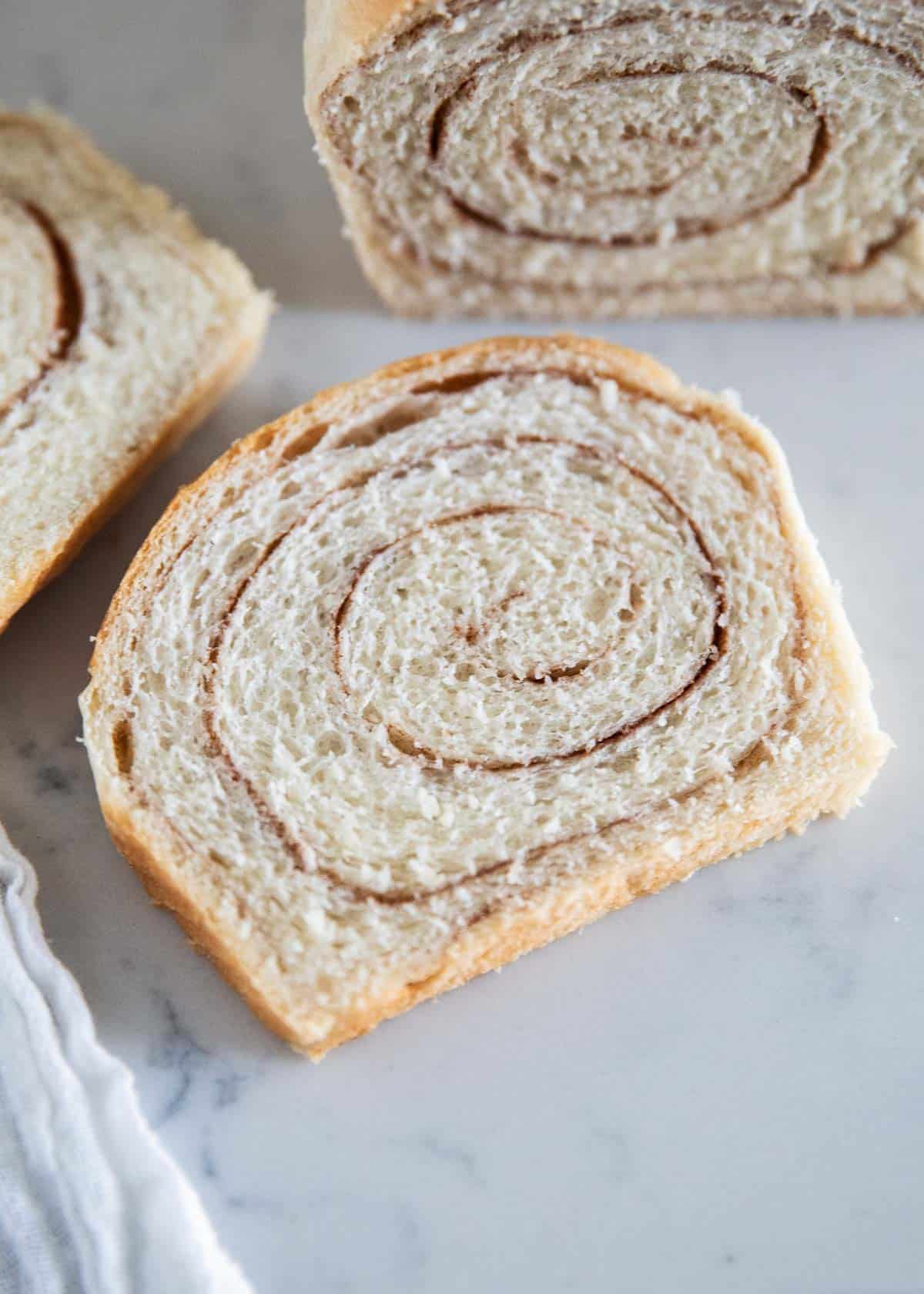 Cinnamon swirl bread slice on table.