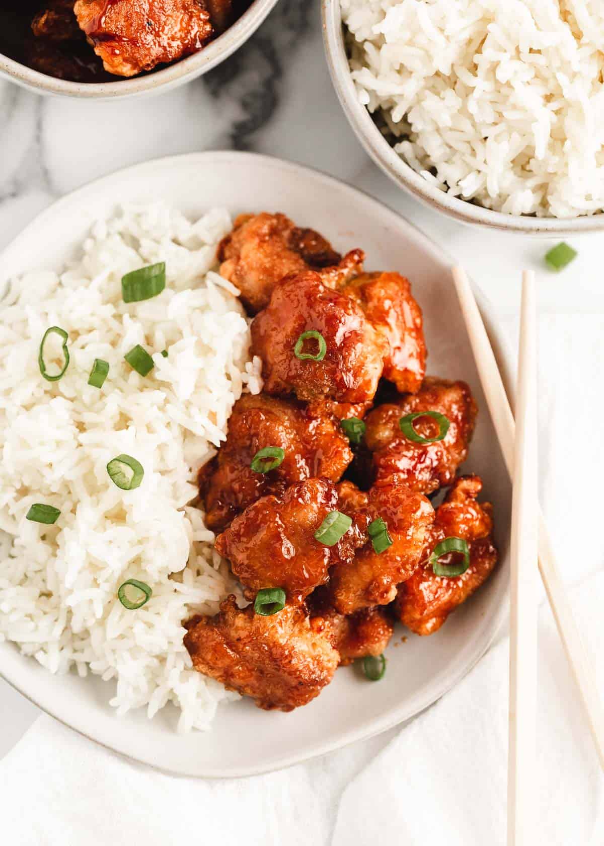 Bowl of sweet and sour chicken over rice.