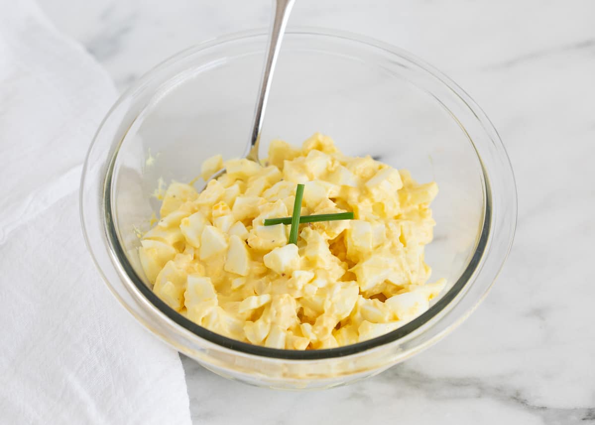 Egg salad in clear bowl.