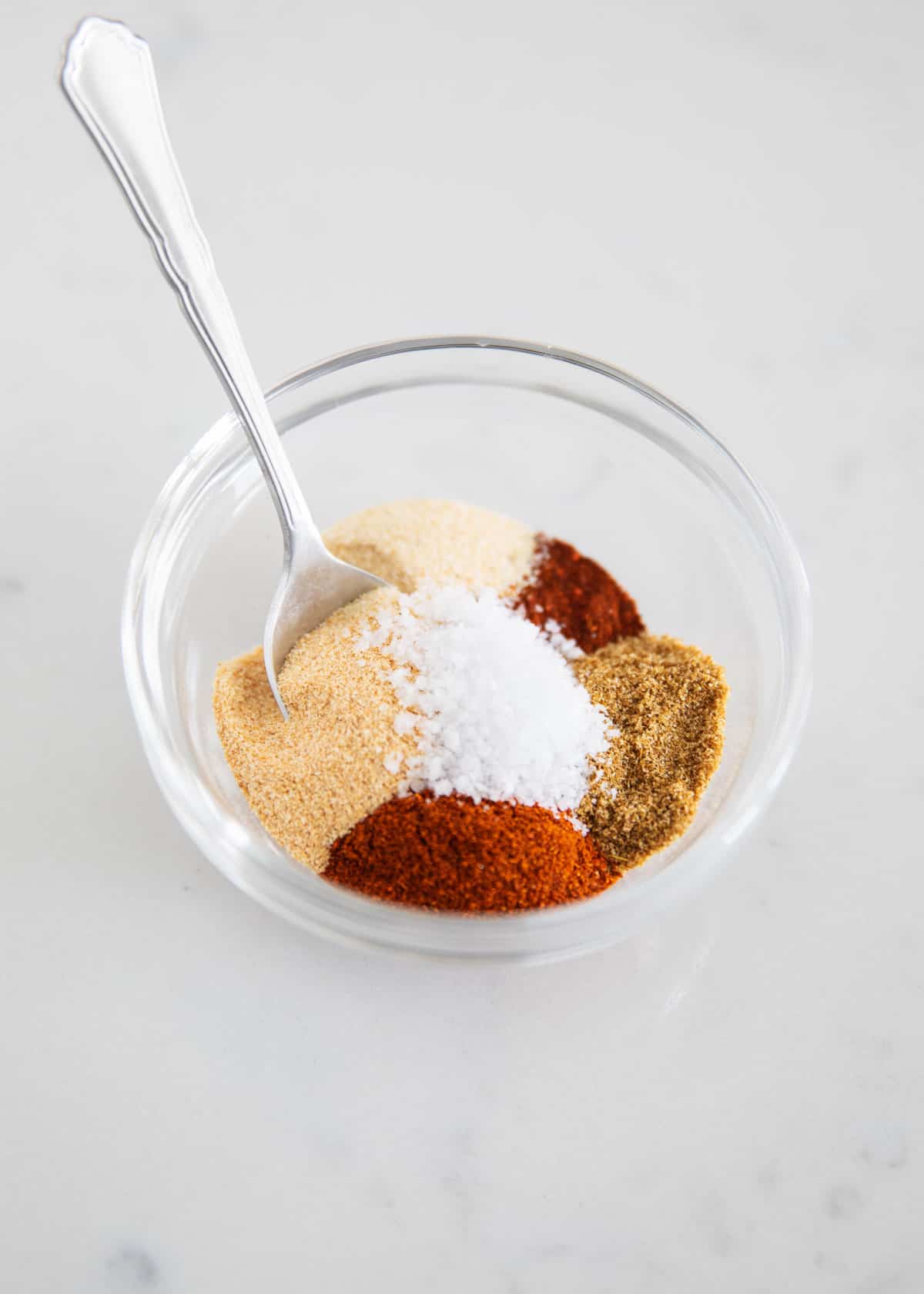 Fajita seasoning ingredients in clear bowl.