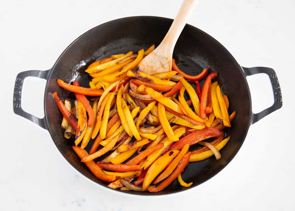 Fajita veggies cooking in pan.