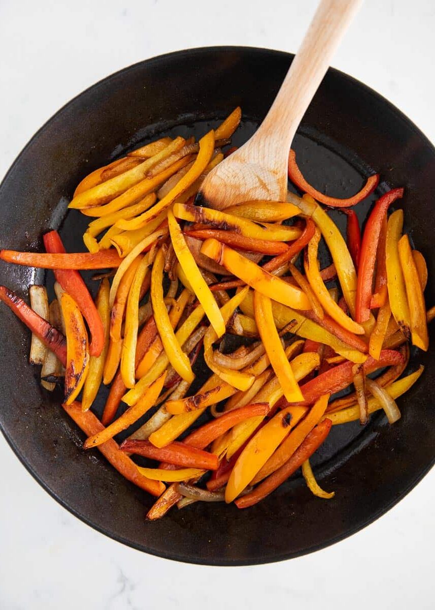 Fajita veggies cooking in pan.