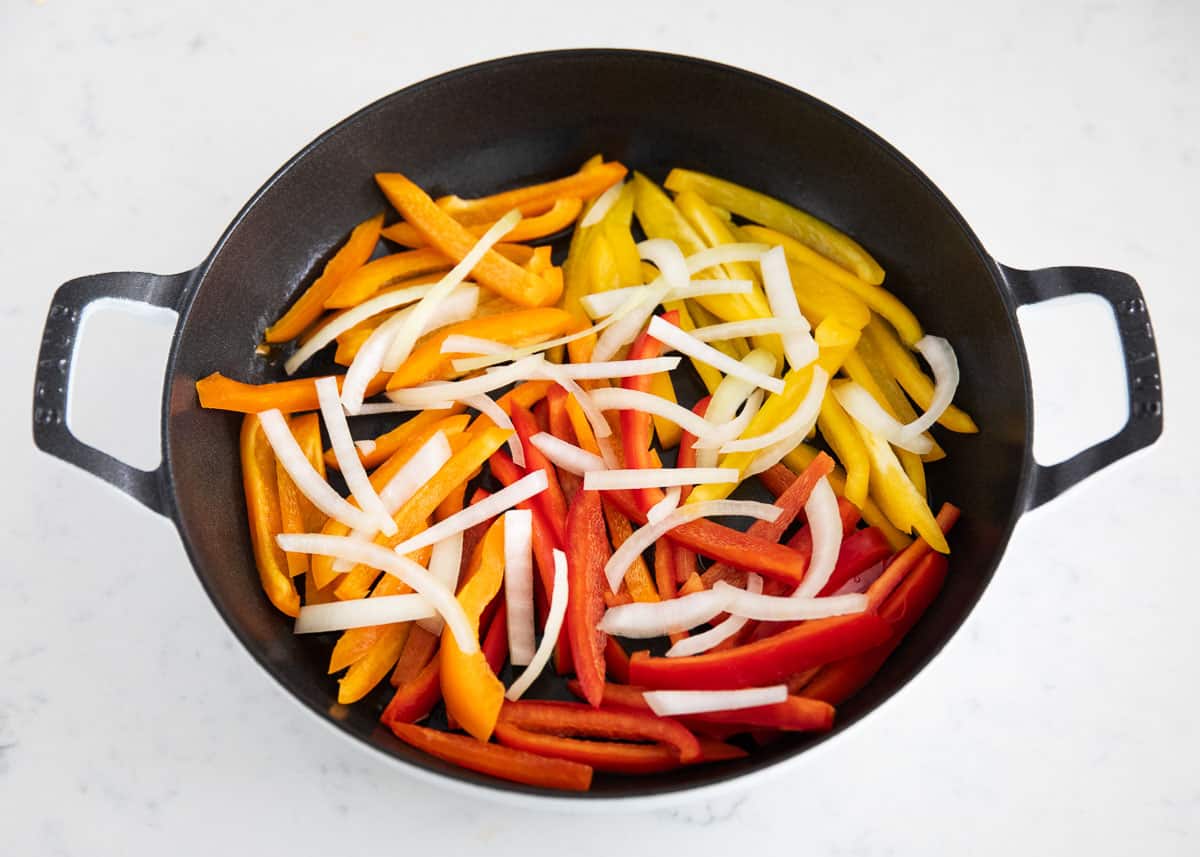 Fajita veggies ingredients in pan.