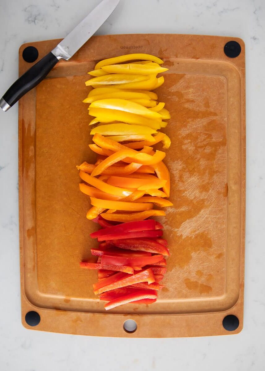 Cut bell peppers on cutting board.