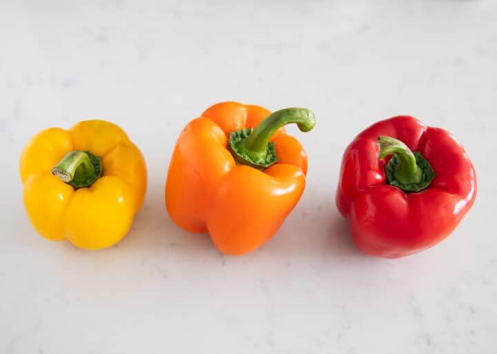 different colored bell peppers on table