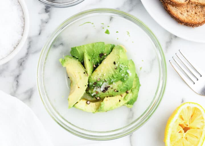 mixing avocado in clear bowl