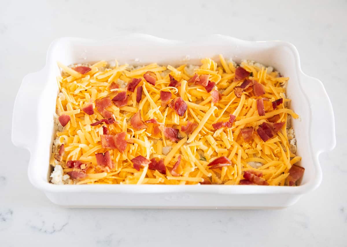 Loaded baked potato casserole in white platter.