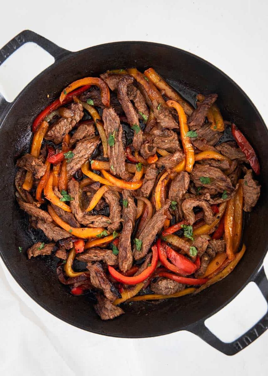 Steak fajitas in pan.