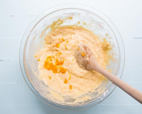 mixing orange icing in bowl