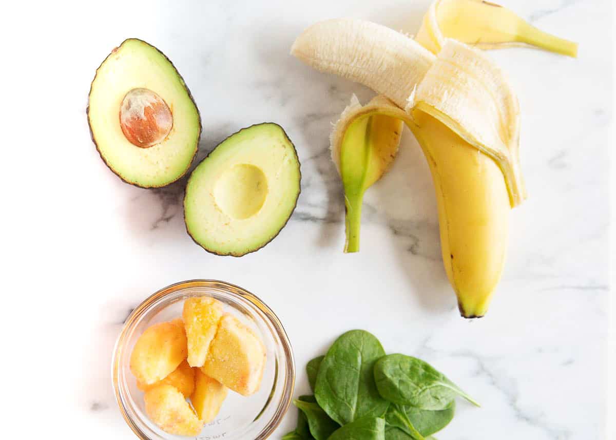 Avocado smoothie ingredients on counter.