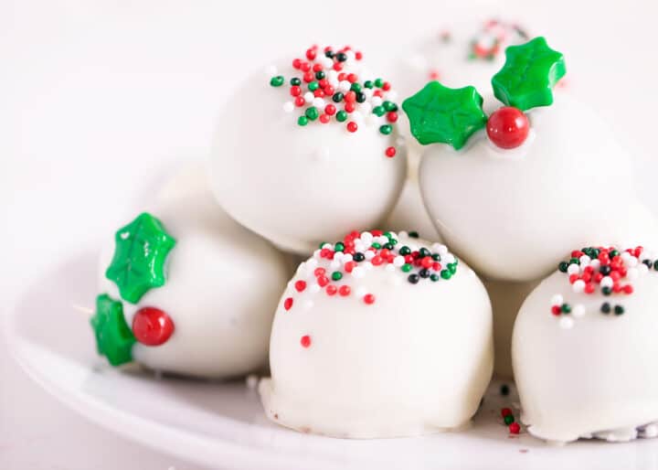 white chocolate christmas oreo balls on white plate