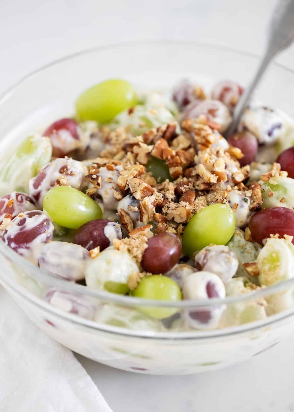 Grape salad in clear bowl close up.