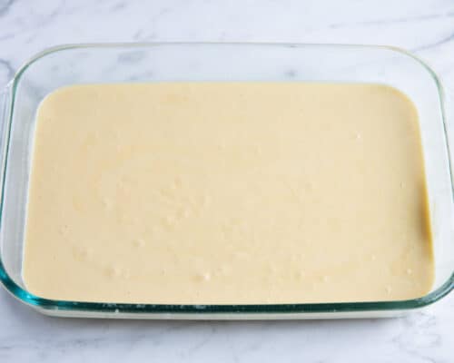 tres leches cake batter in clear pan