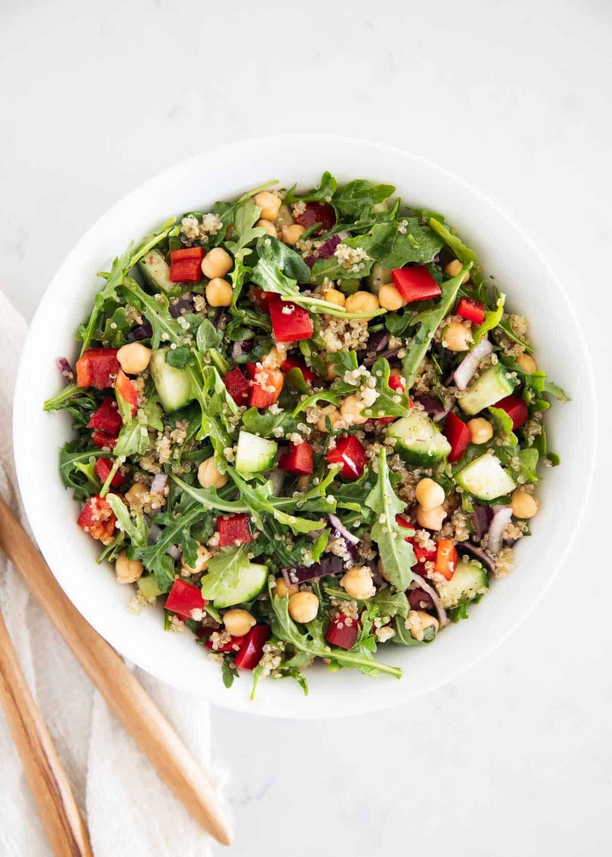 Quinoa mediterranean salad ingredients in bowl.