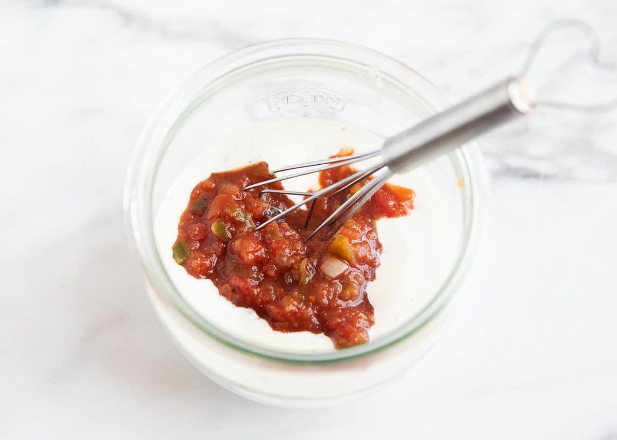 Salsa ranch ingredients in clear bowl.