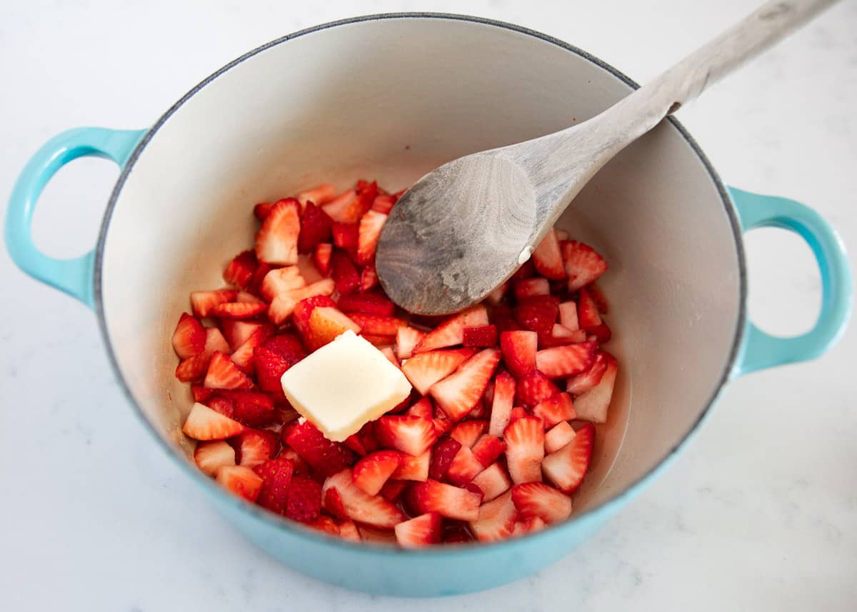 cut strawberries and butter in pan