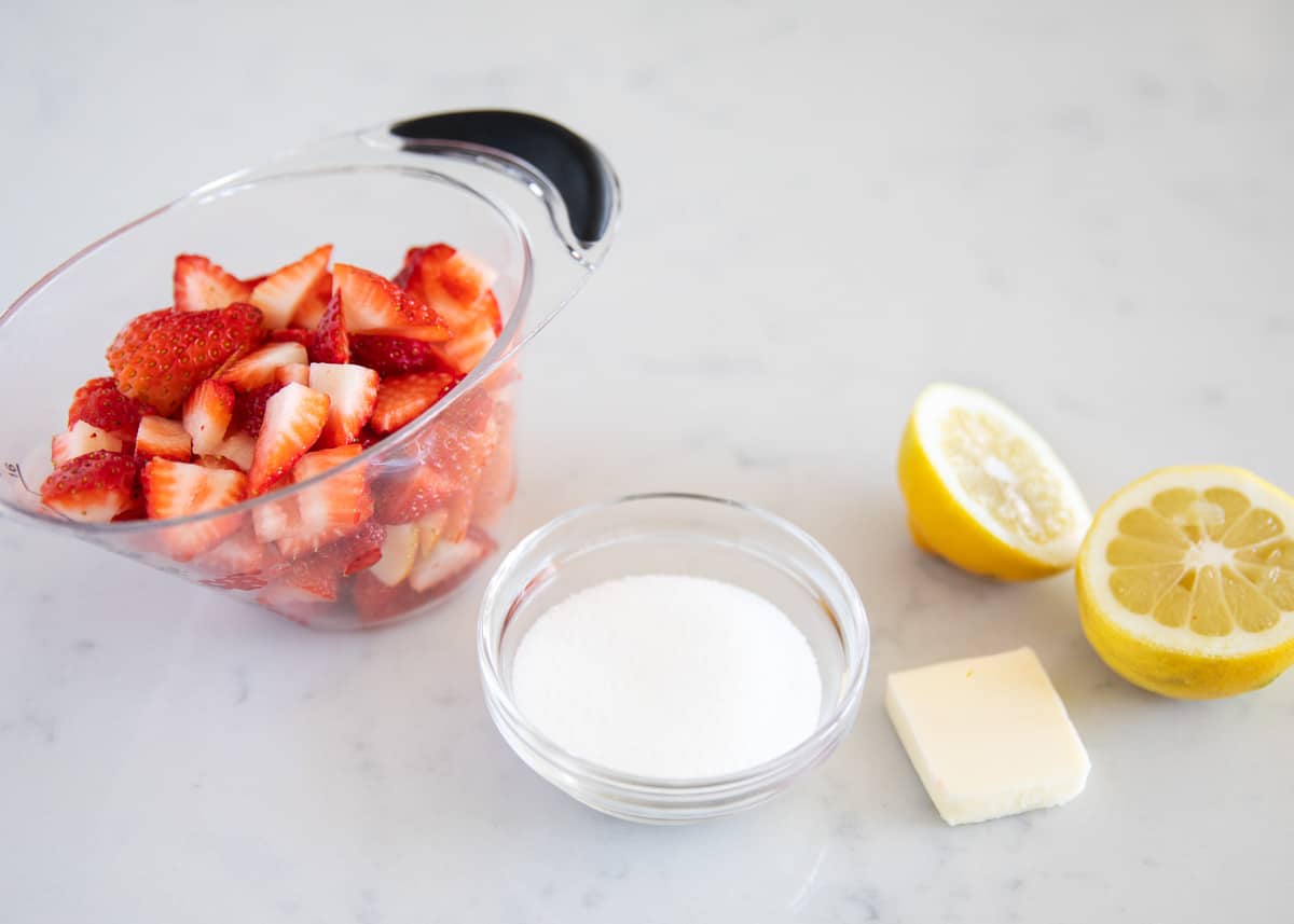 Strawberry sauce ingredients on counter.