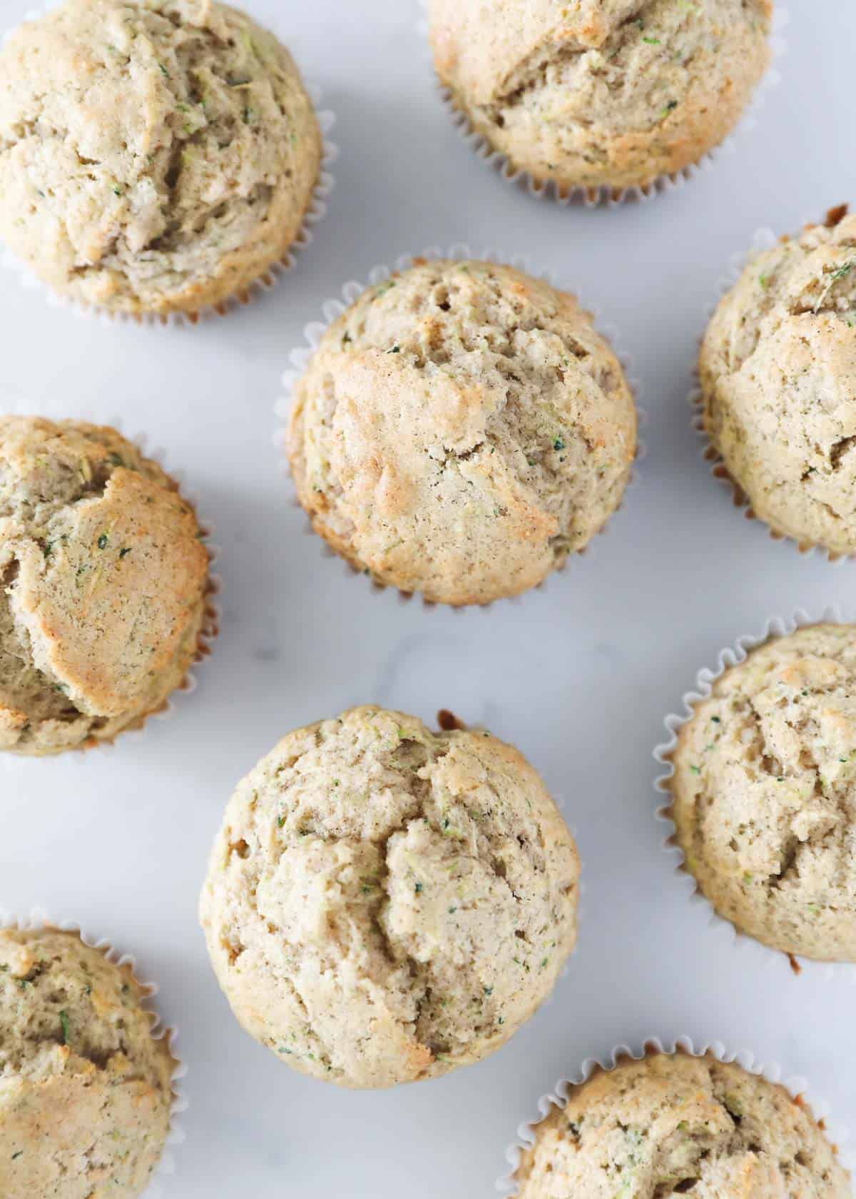 Overhead view of zucchini muffins on counter.