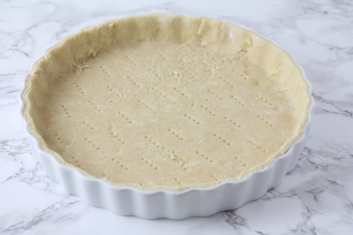 pressing pie crust into tart pan