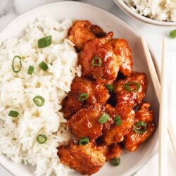 Sweet and sour chicken and rice in a bowl.