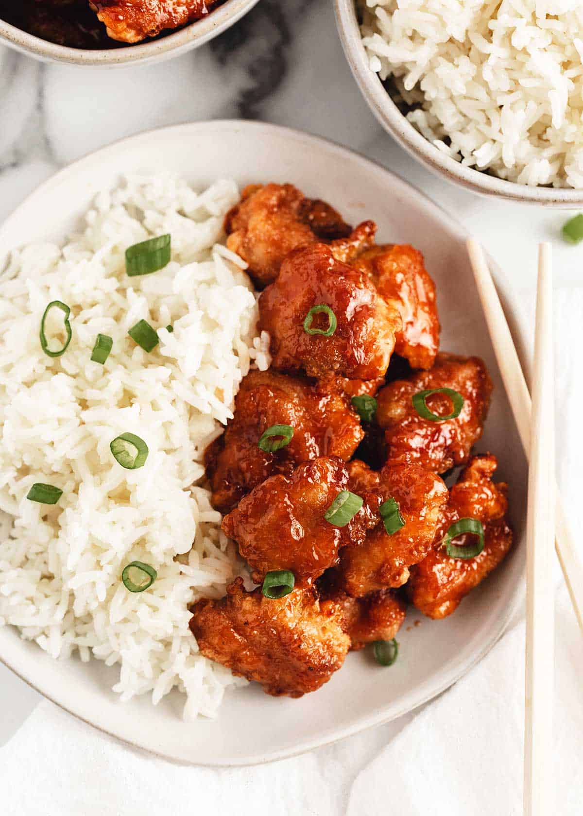 Sweet and sour chicken and rice in a bowl.