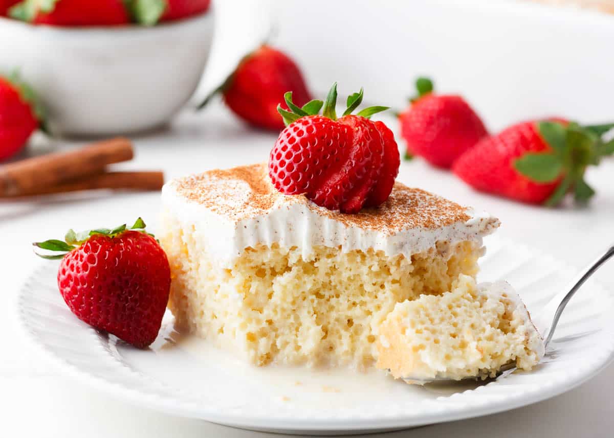 Slice of tres leches cake on a plate. 