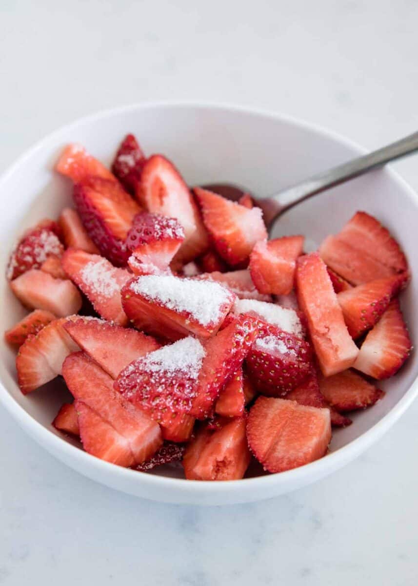 diced strawberries in bowl with sugar on top 