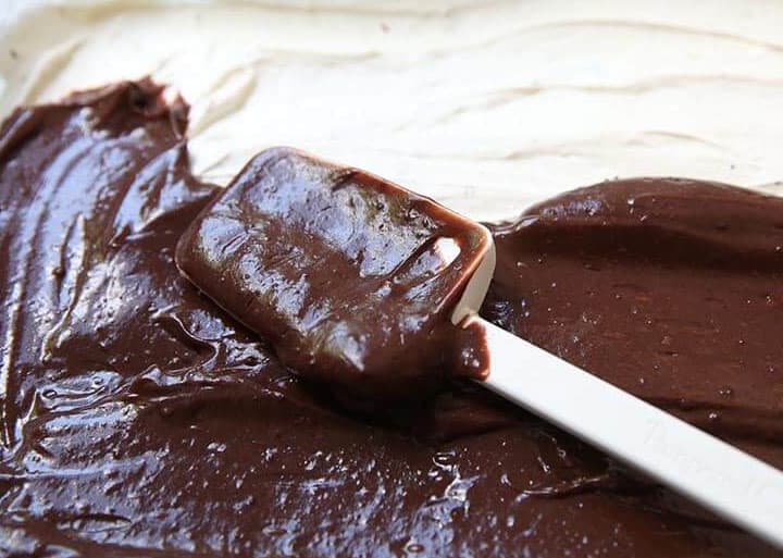 spreading chocolate pudding onto dessert