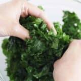 massaging kale in bowl