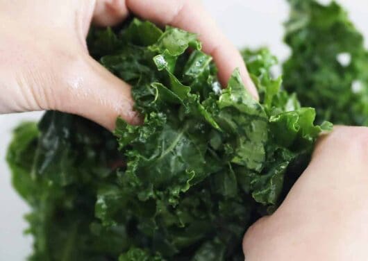 massaging kale in bowl
