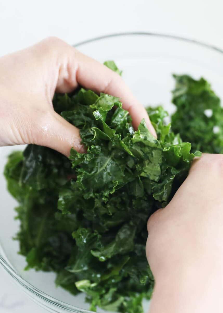 massaging kale in bowl