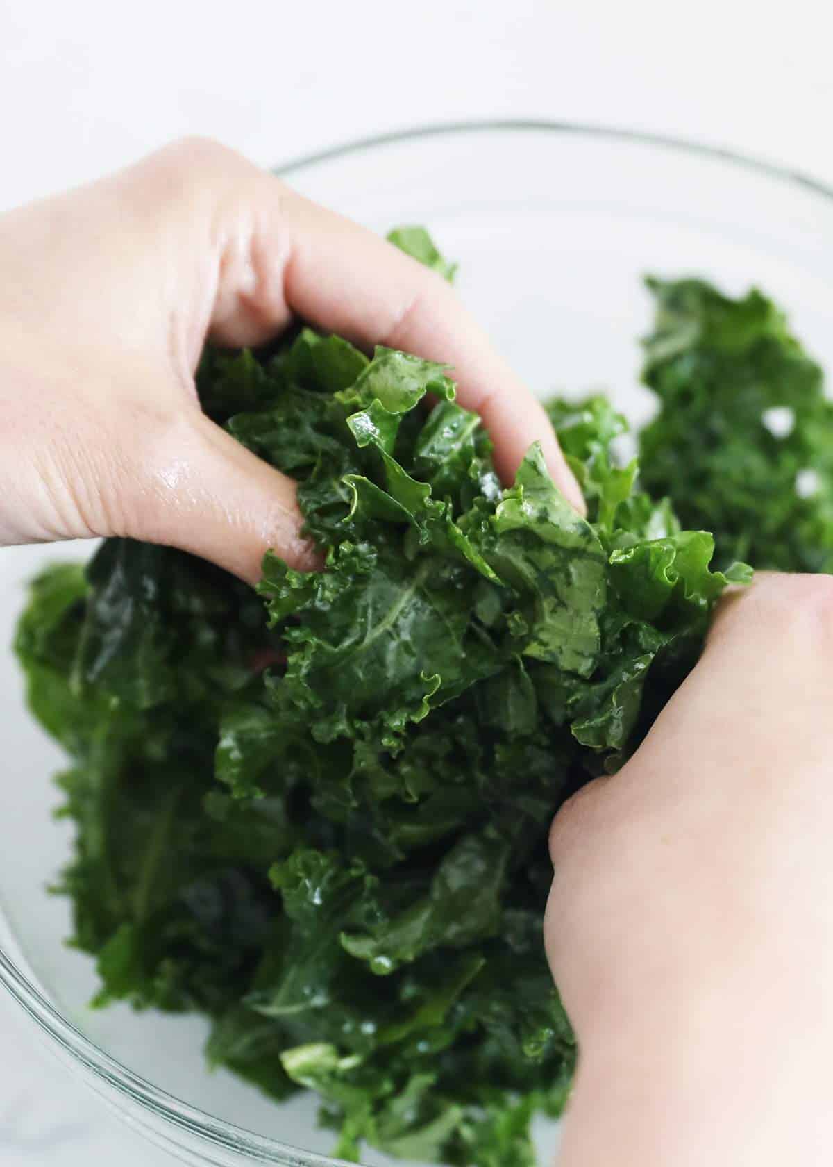 Massaging kale in bowl.